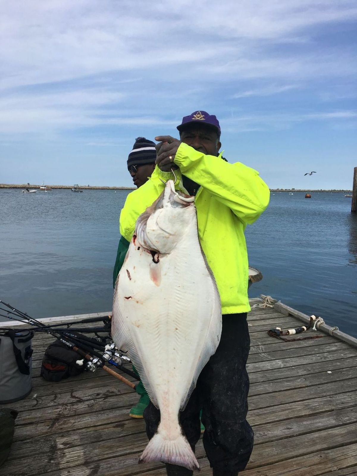 a person holding a fish on a boat in a body of water