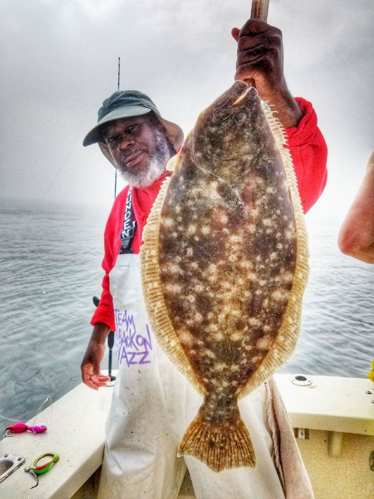 a man standing next to a body of water
