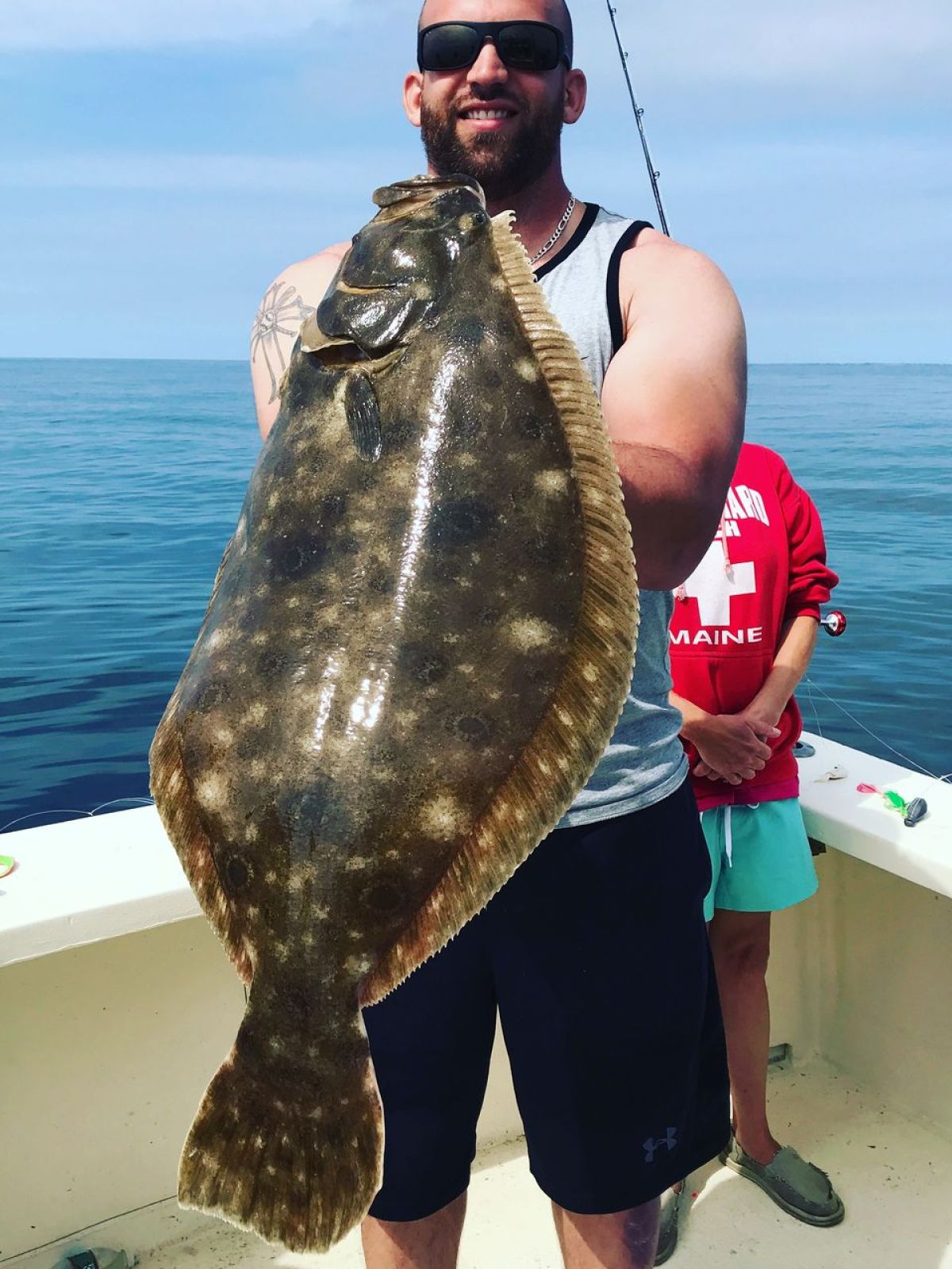 a person holding a fish in the water