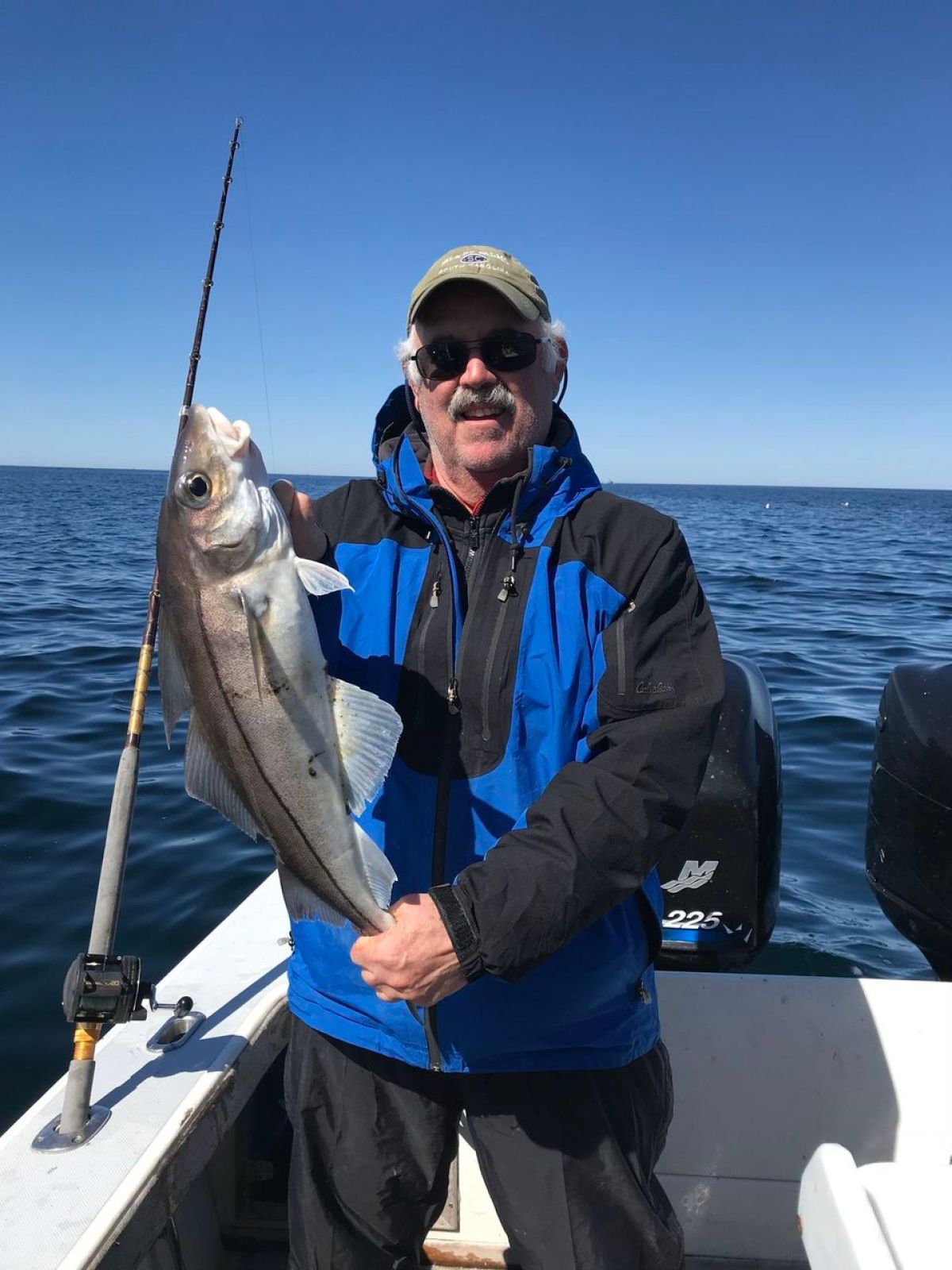 a person holding a fish on a boat