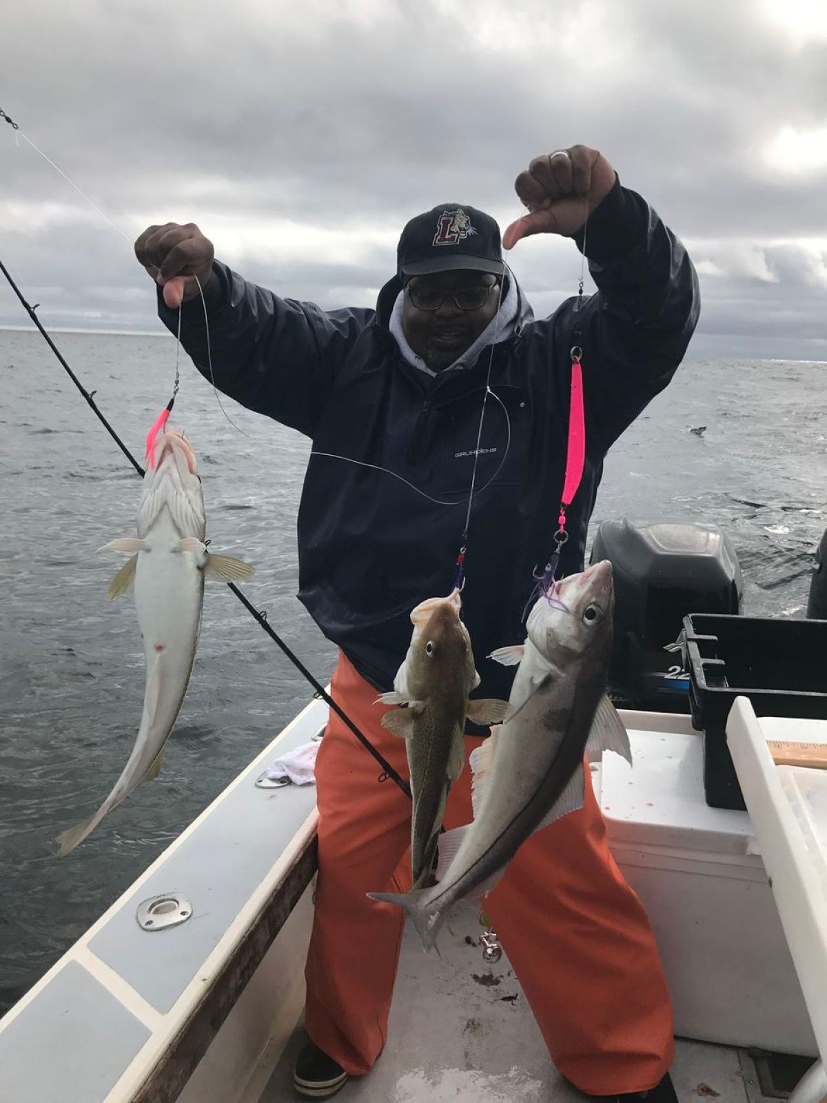 a person holding a fish on a boat