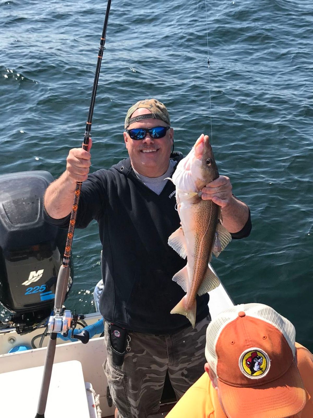 a man holding a fish in the water
