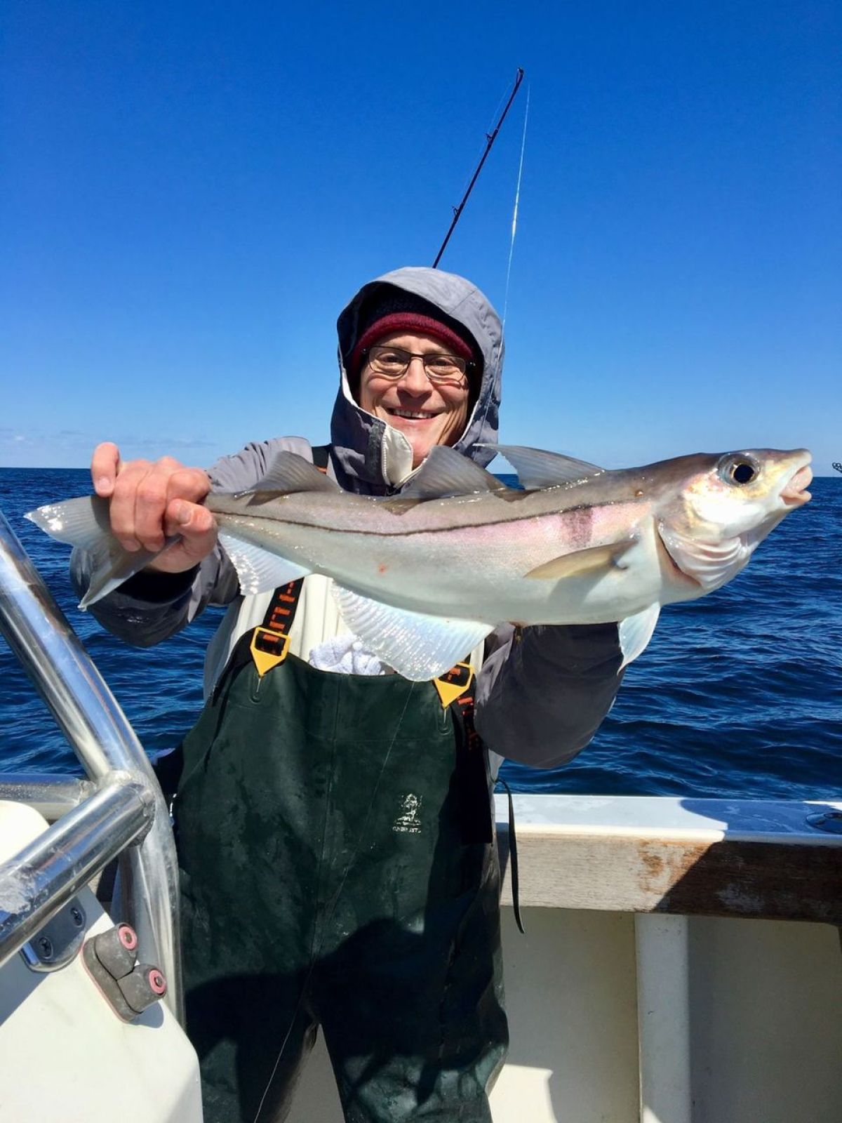 a person holding a fish in the water
