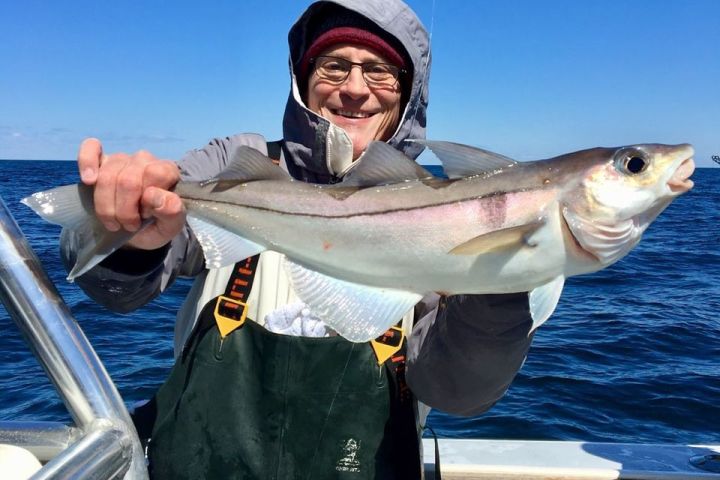 a person holding a fish in the water