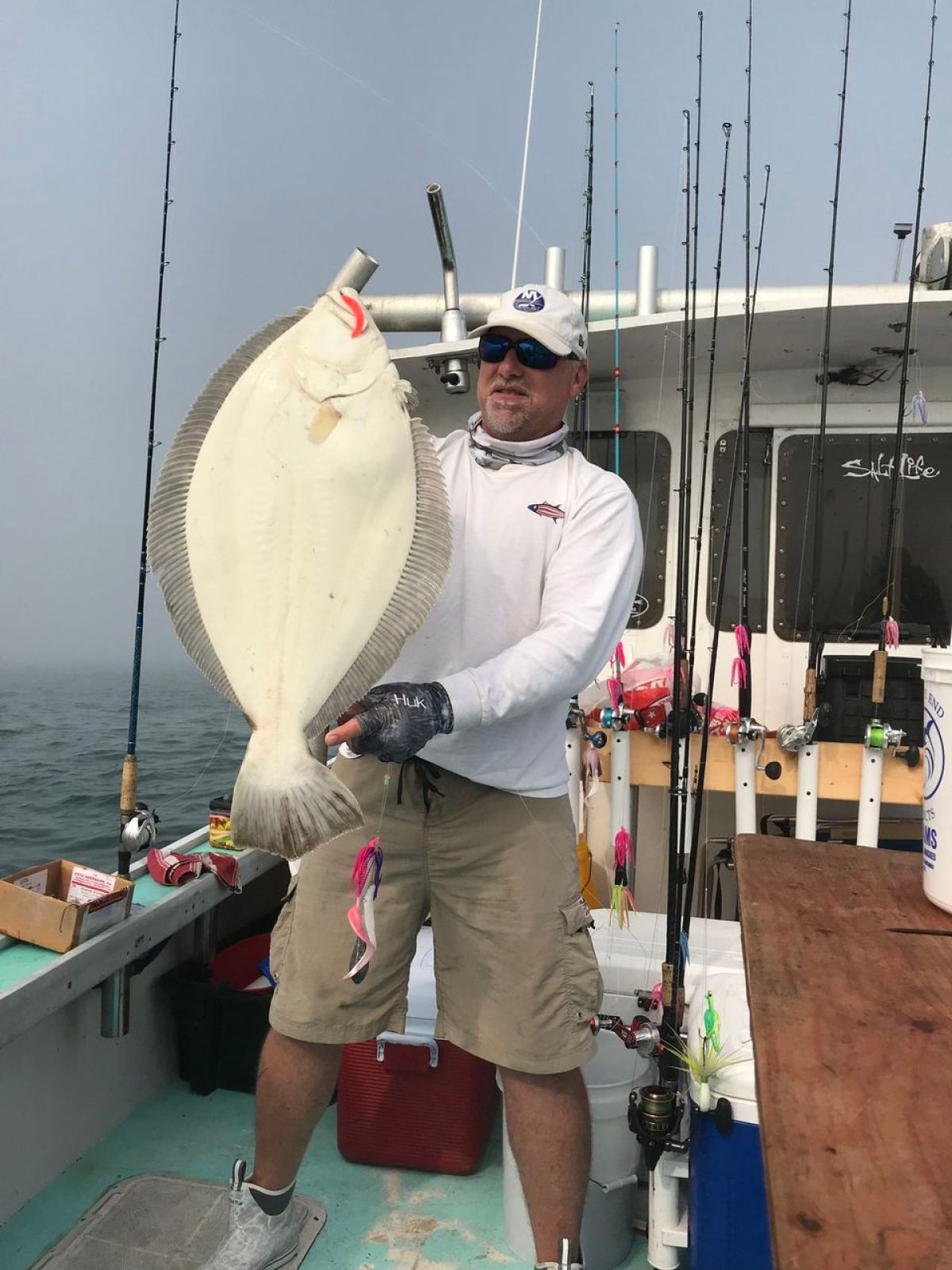 a man holding a fish on a boat