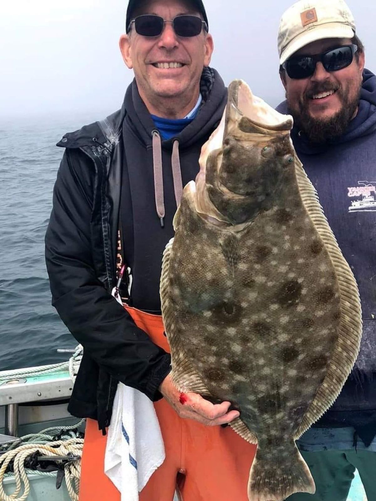 a man holding a fish in the water