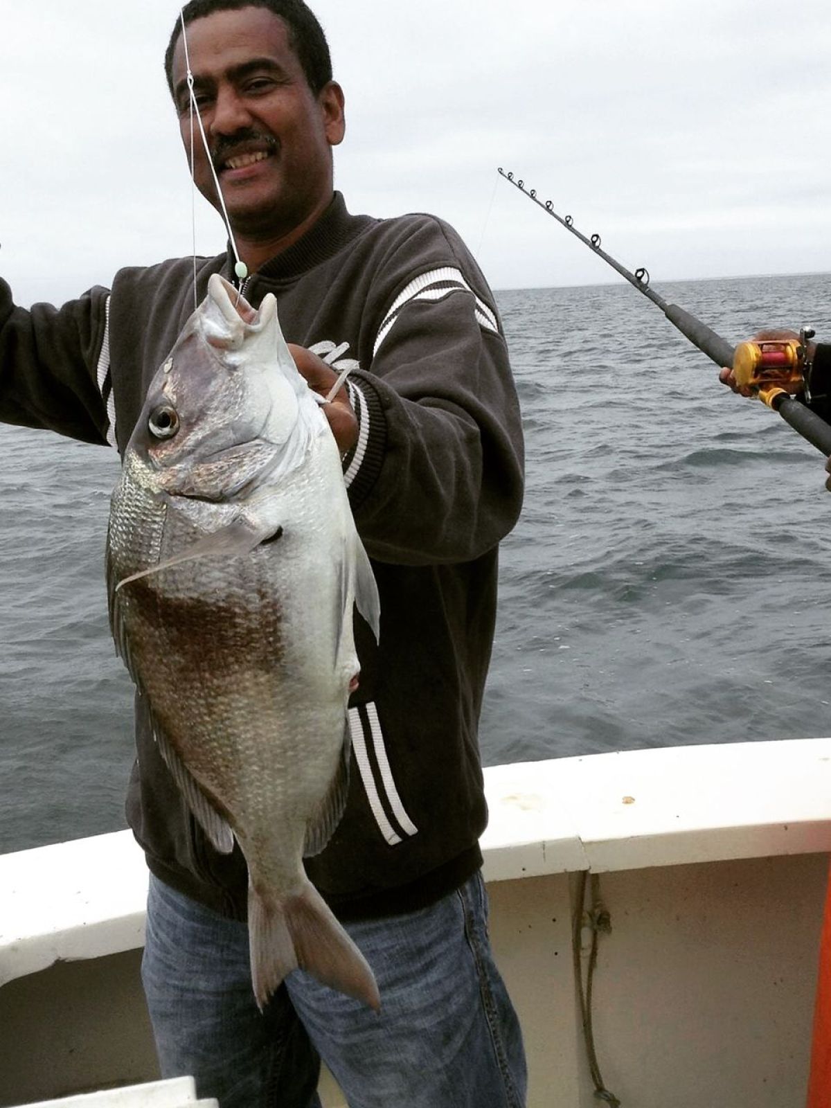 a man holding a fish in the water