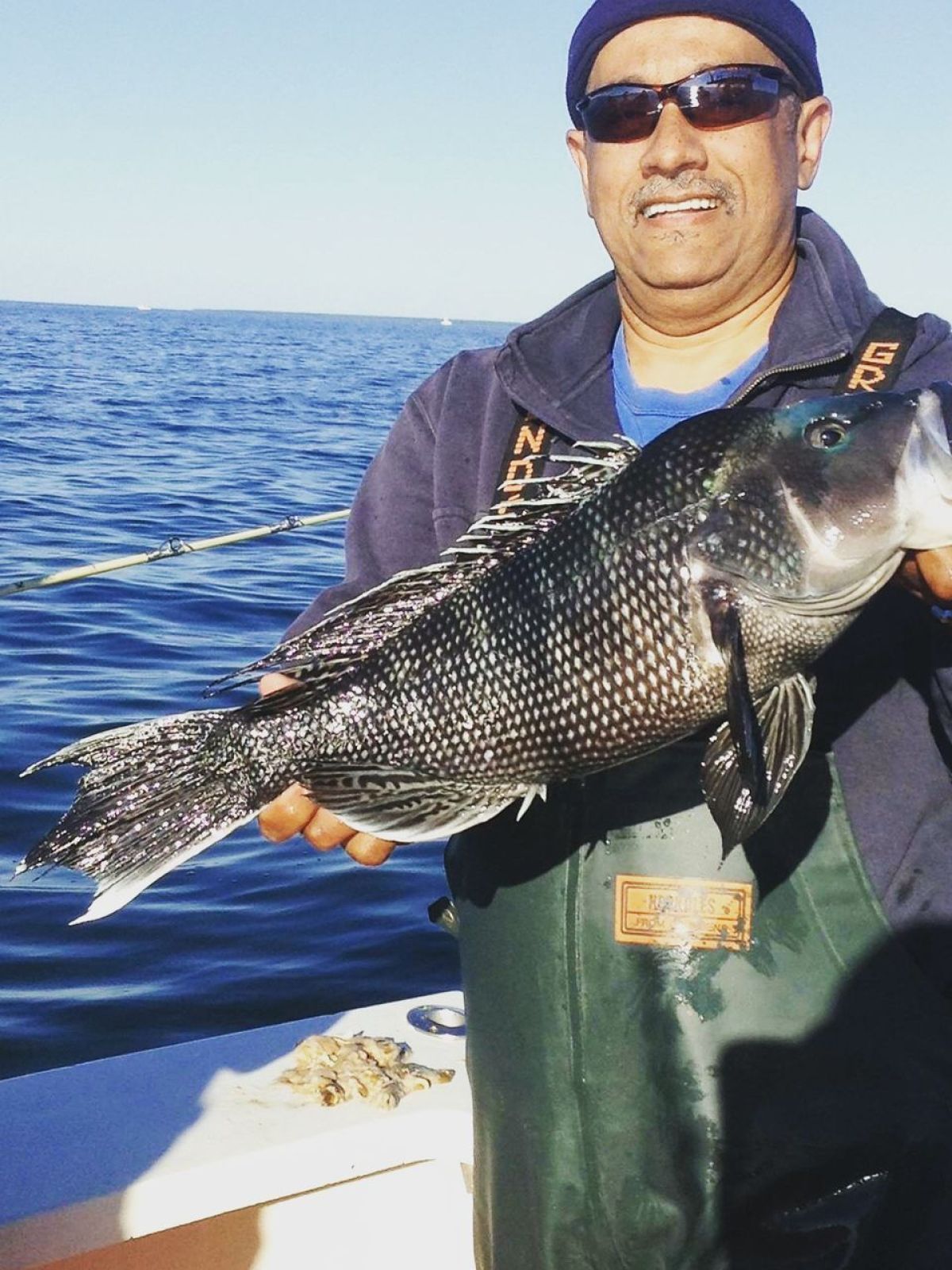 a person holding a fish in the water