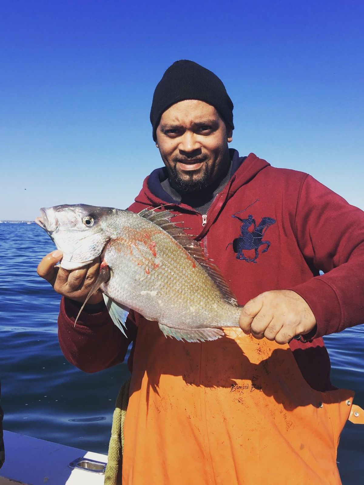 a crab with a man standing next to a body of water