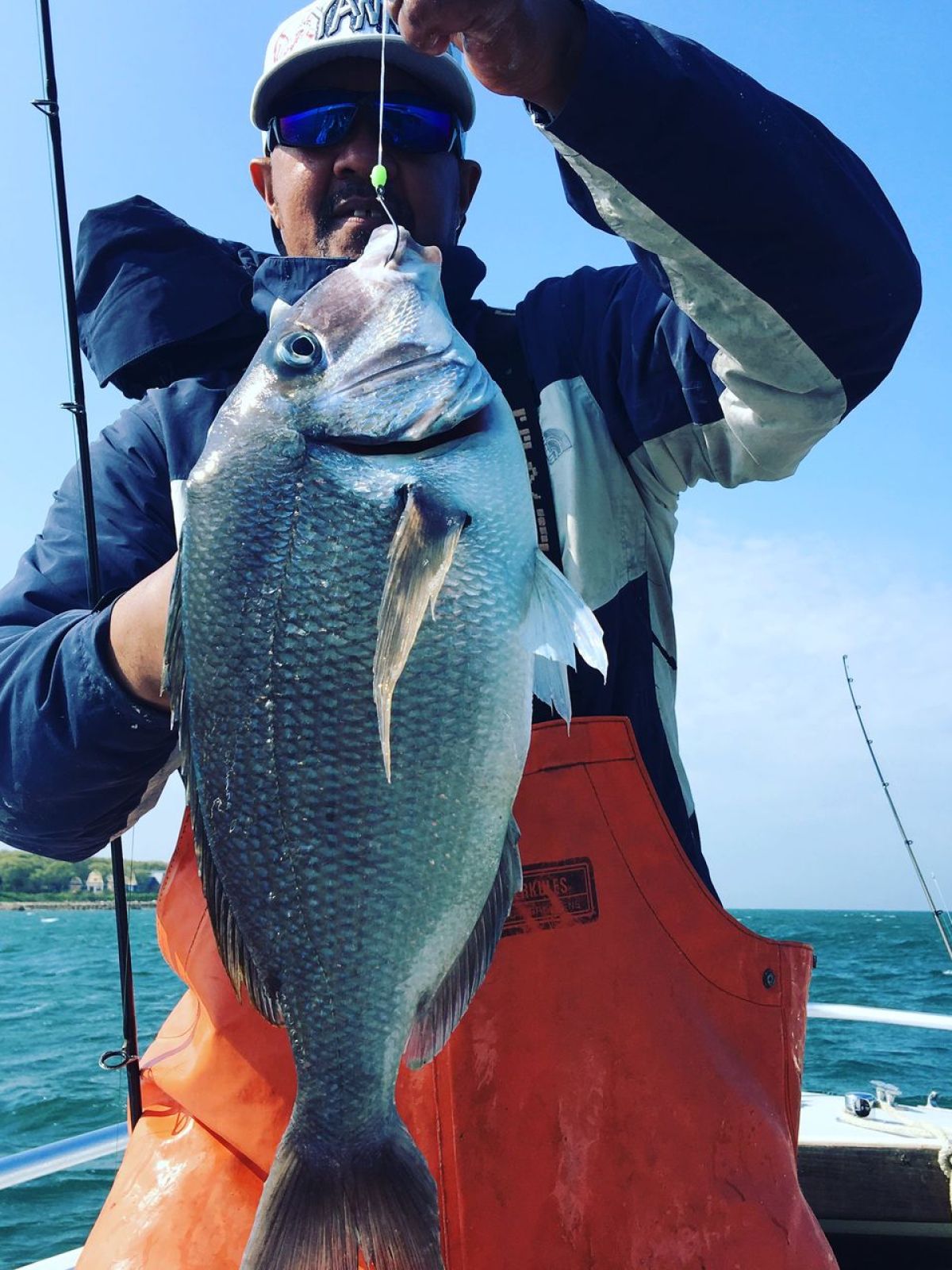 a man riding on the back of a boat in the water