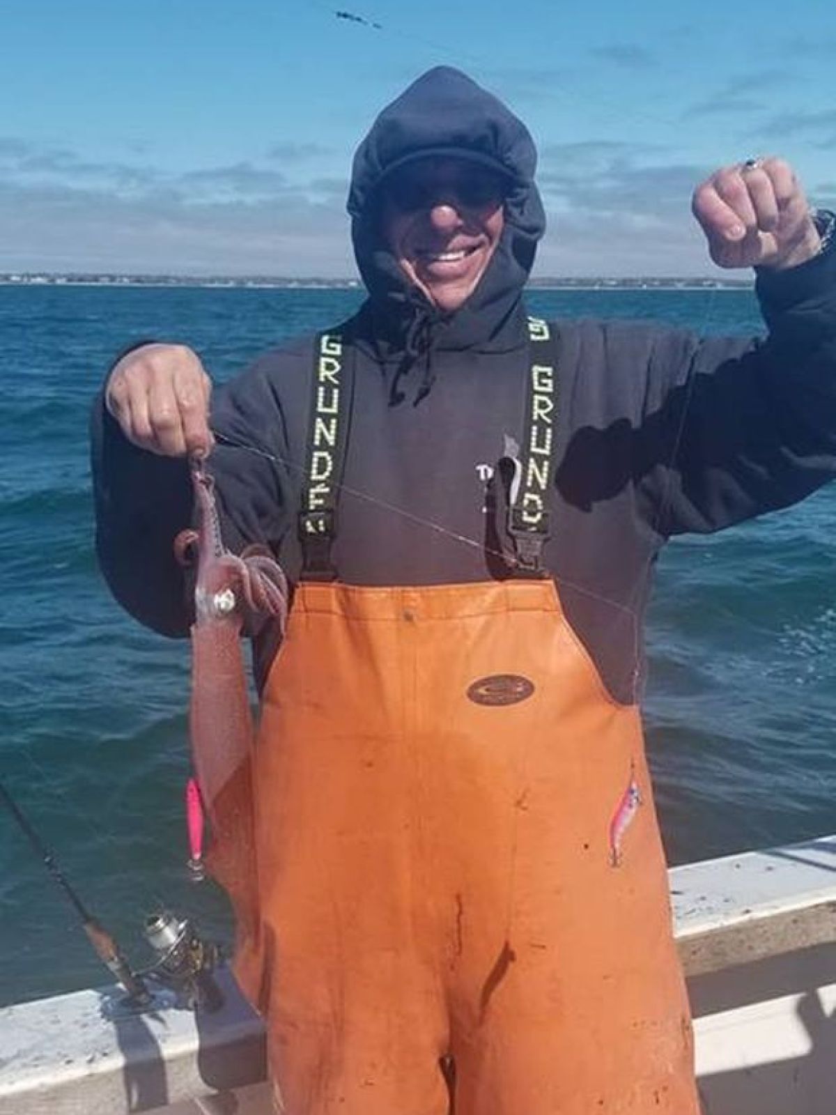 a person holding a fish in the water