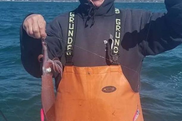 a person holding a fish in the water