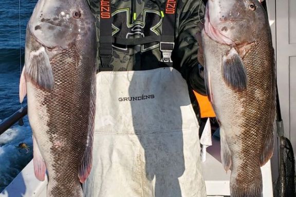 a man holding a fish