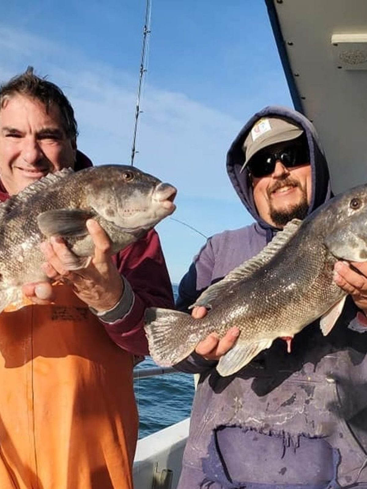 a person holding a fish on a boat